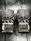 Cleto Reyes Professional boxing gloves in white featuring an intricate black Aztec calendar and tribal art design layout Back View