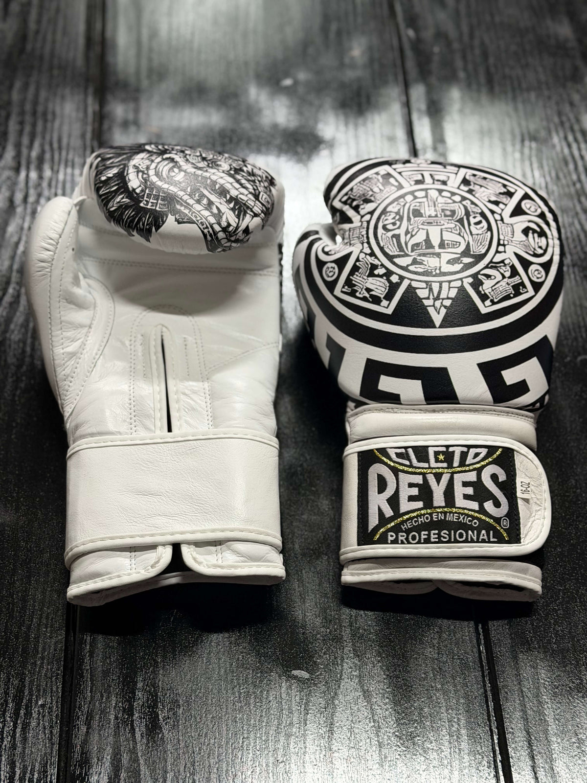 Cleto Reyes Professional boxing gloves in white featuring an intricate black Aztec calendar and tribal art design layout Front View