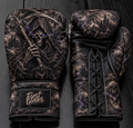 Fiest Gloves custom leather boxing gloves featuring a dark gothic Grim Reaper with glowing purple eyes, skull motifs, and a lace-up design.